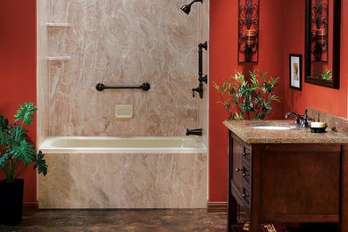 Design ideas for a mid-sized mediterranean 3/4 bathroom in Dallas with shaker cabinets, dark wood cabinets, an alcove tub, a shower/bathtub combo, brown tile, stone slab, red walls, an undermount sink, granite benchtops, brown floor, brown benchtops, a single vanity and a freestanding vanity.