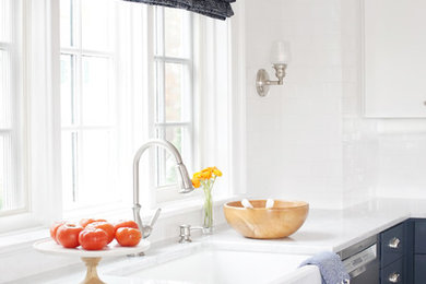 Inspiration for a coastal u-shaped medium tone wood floor and brown floor eat-in kitchen remodel in Bridgeport with flat-panel cabinets, blue cabinets, a farmhouse sink, marble countertops, white backsplash, subway tile backsplash, stainless steel appliances and an island
