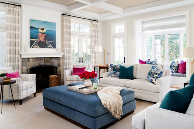 Example of a beach style coffered ceiling living room design in DC Metro with white walls, a standard fireplace and a stone fireplace