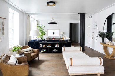 Example of a large trendy open concept medium tone wood floor and brown floor living room design in New York with no fireplace and white walls