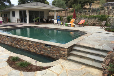 Pool - mid-sized rustic backyard stone and custom-shaped natural pool idea in Other