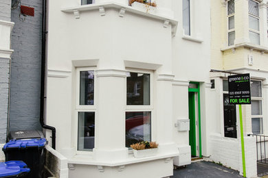 ロンドンにある高級な中くらいなヴィクトリアン調のおしゃれな家の外観 (漆喰サイディング) の写真