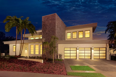 This is an example of a large contemporary attached three-car garage in San Diego.