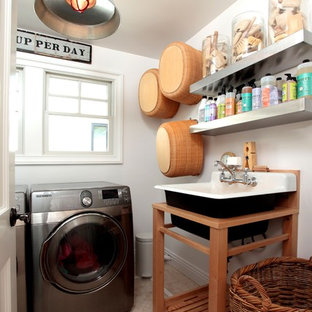Eclectic separated utility room in Los Angeles with a built-in sink and a side by side washer and dryer.
