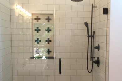 Bathroom - mid-sized eclectic master white tile and ceramic tile ceramic tile and black floor bathroom idea in Milwaukee with furniture-like cabinets, medium tone wood cabinets, a two-piece toilet, white walls, a console sink and a hinged shower door