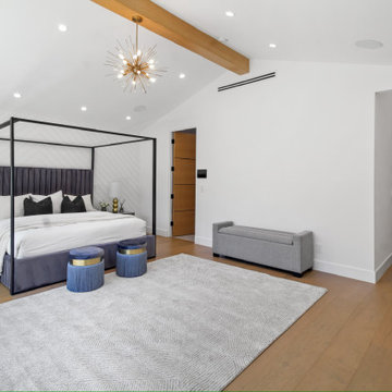 Primary Bedroom with Canopy Bed and Exposed Wood Beam
