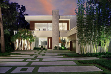 Inspiration for a contemporary two-storey stucco white house exterior in Orlando with a flat roof.