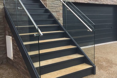 Steel staircase with frameless glass balustrade and stainless steel handrail