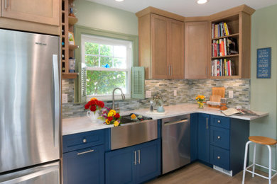 Inspiration for a small craftsman galley vinyl floor kitchen remodel in Other with a farmhouse sink, recessed-panel cabinets, blue cabinets, quartz countertops, multicolored backsplash, glass tile backsplash, stainless steel appliances, no island and white countertops