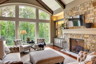 Living room - large transitional open concept dark wood floor and brown floor living room idea in New York with beige walls, a standard fireplace, a stone fireplace and a wall-mounted tv