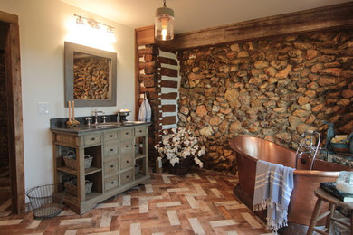 Inspiration for a mid-sized country master beige tile and porcelain tile brick floor and multicolored floor bathroom remodel in Atlanta with furniture-like cabinets, distressed cabinets, a one-piece toilet, white walls, an undermount sink, soapstone countertops and gray countertops