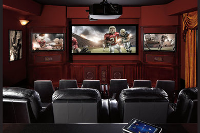Inspiration for a mid-sized contemporary enclosed carpeted home theater remodel in Austin with brown walls and a projector screen