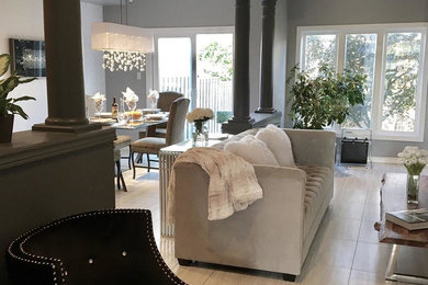 Example of a mid-sized cottage chic formal and open concept porcelain tile living room design in Other with gray walls, no fireplace and no tv