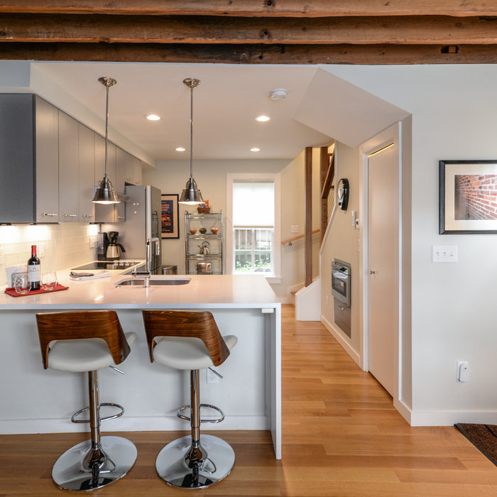 The extended Peninsula with waterfall mitered quartz provides an easy and informal gathering spot where visitors can hang out before heading over to the Big House in Ann Arbor on Football Saturdays.