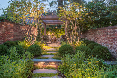 This is an example of a mid-sized traditional shade backyard stone outdoor basketball/tennis/multi-game court in DC Metro for fall.
