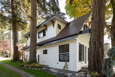 Mid-sized country mixed siding house exterior photo in Other with a gambrel roof, a metal roof and a brown roof