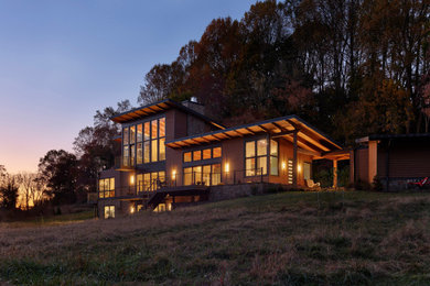 Trendy brown two-story house exterior photo in Philadelphia with a shed roof and a metal roof