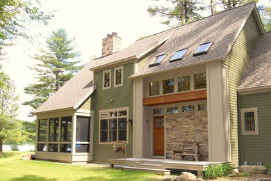 Inspiration for a large traditional two-storey green exterior in Boston with mixed siding and a clipped gable roof.