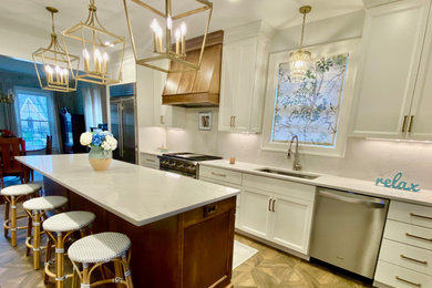 Example of a mid-sized transitional ceramic tile and brown floor eat-in kitchen design in Louisville with a drop-in sink, recessed-panel cabinets, white cabinets, quartz countertops, white backsplash, quartz backsplash, stainless steel appliances, an island and white countertops