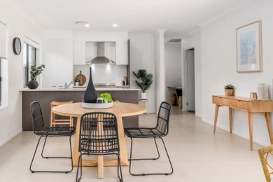 This is an example of a small contemporary open plan dining in Newcastle - Maitland with white walls.