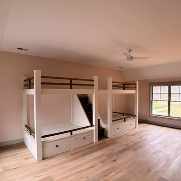 Spacious Shared Kids Room with Custom Bunk Beds, Integrated Drawers, and Vaulted