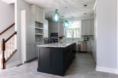 Example of a large transitional u-shaped ceramic tile and multicolored floor open concept kitchen design in DC Metro with a farmhouse sink, raised-panel cabinets, gray cabinets, quartz countertops, multicolored backsplash, glass tile backsplash, stainless steel appliances, an island and multicolored countertops
