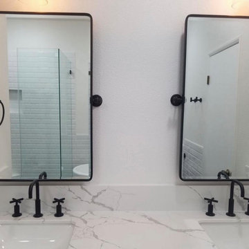 Beautiful, sleek, curb-less white and black shower and tub bathroom
