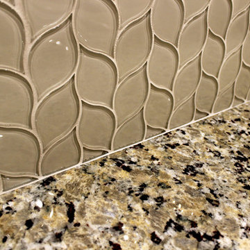 Medallion Painted White Chocolate Kitchen Cabinets with Petal Mosaic Backsplash