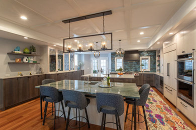 Inspiration for a huge medium tone wood floor kitchen remodel in Minneapolis with a drop-in sink, flat-panel cabinets, light wood cabinets, quartzite countertops, green backsplash, stainless steel appliances, two islands, green countertops and porcelain backsplash