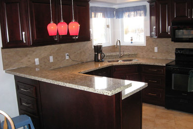 Inspiration for a timeless u-shaped eat-in kitchen remodel in Other with an undermount sink, raised-panel cabinets, red cabinets, granite countertops, beige backsplash and a peninsula