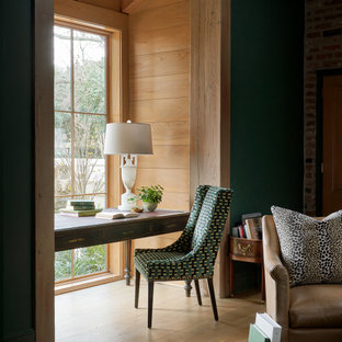 Cette image montre un grand bureau traditionnel avec un mur vert, un sol en bois brun, une cheminée standard, un manteau de cheminée en pierre de parement, un bureau indépendant, un sol marron et un mur en parement de brique.