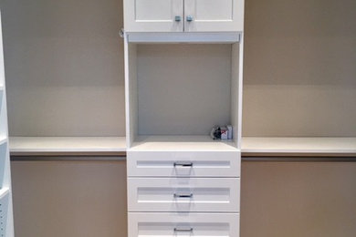 Walk-in closet - mid-sized traditional gender-neutral light wood floor walk-in closet idea in Miami with shaker cabinets and white cabinets