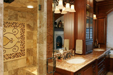 Example of a classic bathroom design in Portland with an undermount sink, raised-panel cabinets, distressed cabinets and granite countertops