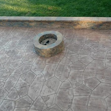 Stamped concrete patio with block seating wall and block fire-pit