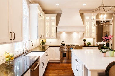 Example of a transitional kitchen design in Nashville with shaker cabinets, white cabinets, quartz countertops, white backsplash, subway tile backsplash, stainless steel appliances and black countertops