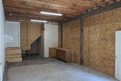 Example of a mid-sized country detached garage workshop design in Boston