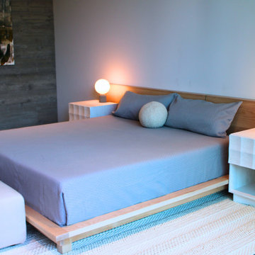 Minimalist Guest Bedroom with Board-Formed Concrete Accent