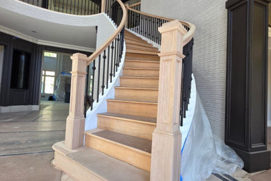 Example of a large trendy wooden curved mixed material railing staircase design in New York with wooden risers