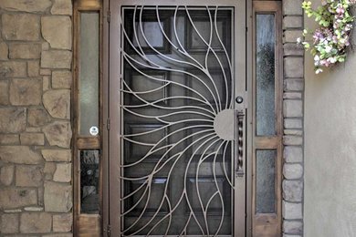 Inspiration for a large eclectic entryway remodel in Phoenix with a brown front door