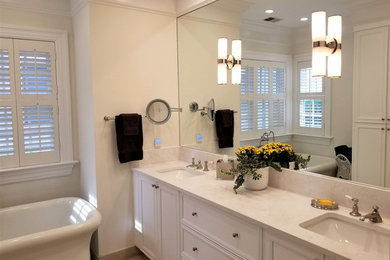 Mid-sized transitional master bathroom in Other with recessed-panel cabinets, white cabinets, a freestanding tub, an alcove shower, a one-piece toilet, yellow tile, yellow walls, porcelain floors, an undermount sink, engineered quartz benchtops, beige floor, a hinged shower door and beige benchtops.