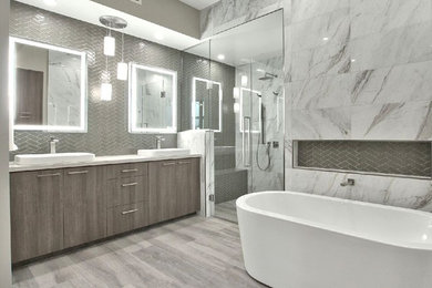 Bathroom - modern master gray tile and glass tile light wood floor bathroom idea in Phoenix with white walls, a pedestal sink, marble countertops, a hinged shower door and white countertops