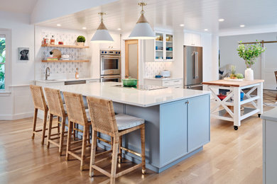 Eat-in kitchen - mid-sized coastal shiplap ceiling eat-in kitchen idea in Boston with blue cabinets, blue backsplash, marble backsplash, stainless steel appliances, two islands and white countertops