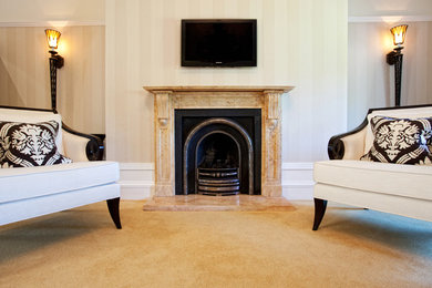 Large classic master bedroom in Other with a stone fireplace surround.