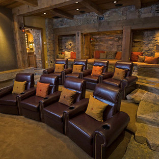 Photo of a rustic enclosed home cinema in Other with a projector screen.