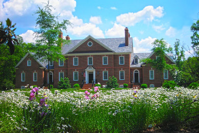 Large elegant red two-story brick gable roof photo in Richmond