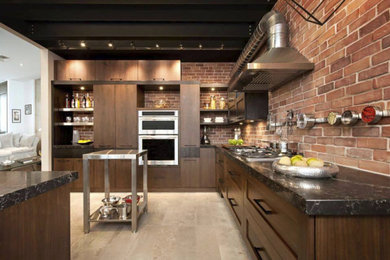 Design ideas for a mid-sized industrial u-shaped separate kitchen in Toronto with a double-bowl sink, flat-panel cabinets, dark wood cabinets, quartzite benchtops, red splashback, brick splashback, stainless steel appliances, dark hardwood floors, with island and brown floor.