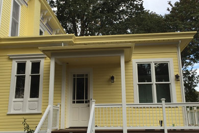 Mid-sized traditional yellow two-story house exterior idea in Other