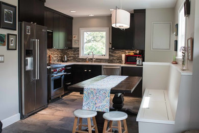 Inspiration for a mid-sized timeless l-shaped porcelain tile enclosed kitchen remodel in Portland with an undermount sink, flat-panel cabinets, dark wood cabinets, quartz countertops, multicolored backsplash, glass tile backsplash, stainless steel appliances and no island
