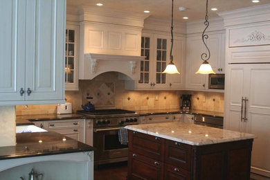 Enclosed kitchen - mid-sized traditional u-shaped dark wood floor and brown floor enclosed kitchen idea in Chicago with beaded inset cabinets, white cabinets, granite countertops, beige backsplash, stone tile backsplash, stainless steel appliances, an island and a farmhouse sink