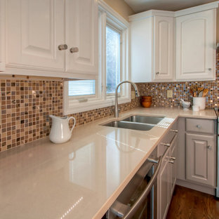 Mid-sized contemporary kitchen pantry ideas - Example of a mid-sized trendy u-shaped medium tone wood floor kitchen pantry design in St Louis with an undermount sink, recessed-panel cabinets, gray cabinets, quartzite countertops, metallic backsplash, glass tile backsplash, stainless steel appliances and no island